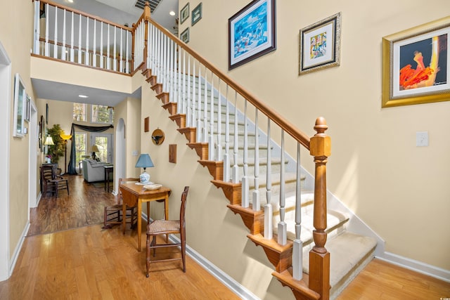 509 June Bug Ct, Myrtle Beach, SC 29588 - stairway with wood finished floors, a towering ceiling, and arched walkways