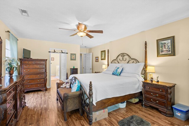 509 June Bug Ct, Myrtle Beach, SC 29588 - bedroom with wood finished floors, ceiling fan, and ensuite bathroom