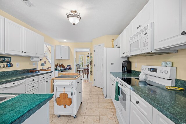 509 June Bug Ct, Myrtle Beach, SC 29588 - kitchen featuring white appliances, white cabinetry, dark countertops, and light tile patterned flooring