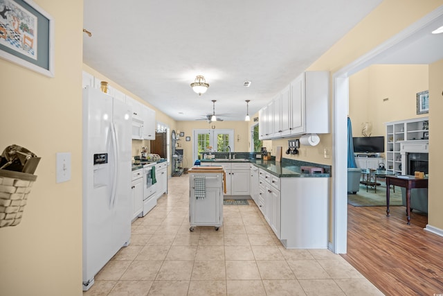 509 June Bug Ct, Myrtle Beach, SC 29588 - kitchen featuring white appliances, ceiling fan, white cabinets, and dark countertops