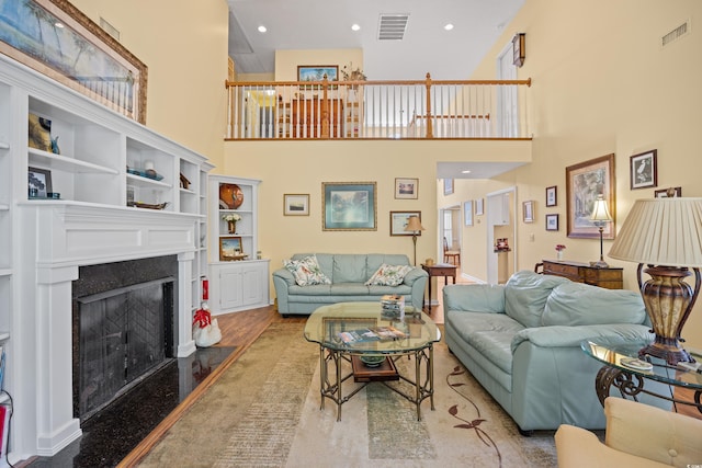 509 June Bug Ct, Myrtle Beach, SC 29588 - living area featuring a towering ceiling, a fireplace, wood finished floors, and recessed lighting