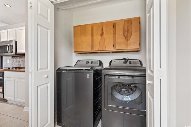 1007 Autumn Dr, Murrells Inlet, SC 29576 - laundry room with cabinet space, light tile patterned flooring, washing machine and dryer, and beverage cooler