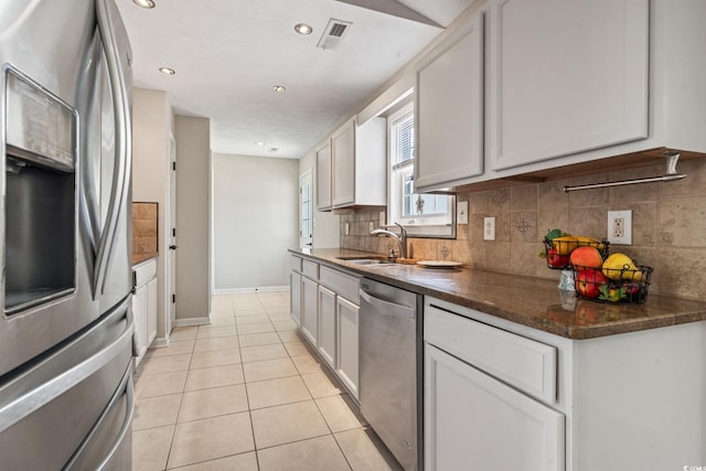 1007 Autumn Dr, Murrells Inlet, SC 29576 - kitchen featuring appliances with stainless steel finishes, decorative backsplash, light tile patterned floors, white cabinets, and recessed lighting