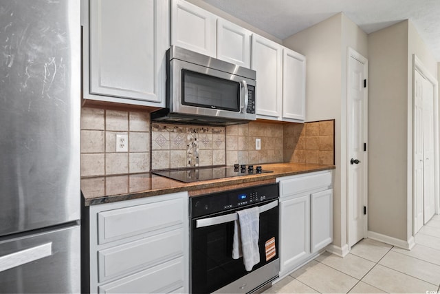 1007 Autumn Dr, Murrells Inlet, SC 29576 - kitchen with appliances with stainless steel finishes, white cabinetry, light tile patterned floors, and decorative backsplash