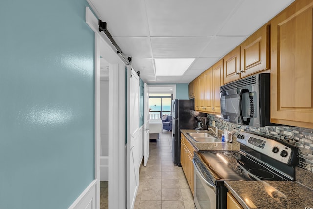1501 S Ocean Blvd Unit 639, Myrtle Beach, SC 29577 - kitchen with stainless steel range with electric stovetop, black microwave, a barn door, tasteful backsplash, and dark countertops