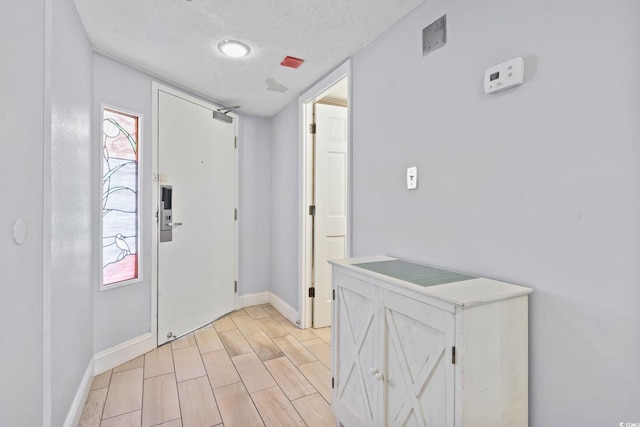 4800 S Ocean Blvd Unit 1008, North Myrtle Beach, SC 29582 - foyer featuring baseboards and a textured ceiling