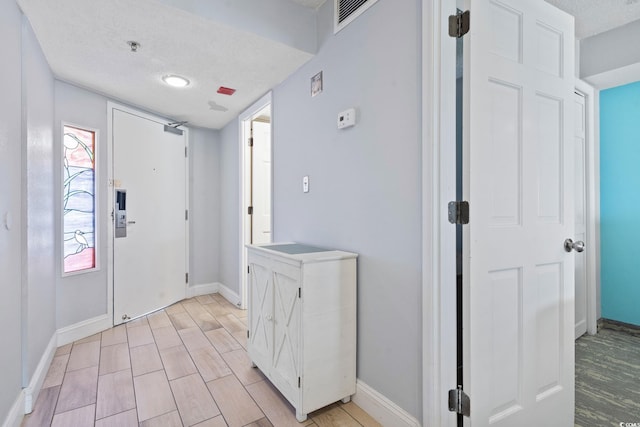 4800 S Ocean Blvd Unit 1008, North Myrtle Beach, SC 29582 - entryway featuring a textured ceiling and light wood-type flooring
