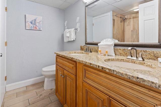 4800 S Ocean Blvd Unit 1008, North Myrtle Beach, SC 29582 - full bathroom featuring a drop ceiling, double vanity, wood finish floors, and tiled shower