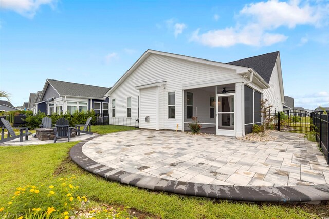 5087 Sundrop Ln, Little River, SC 29566 - rear view of house featuring an outdoor fire pit, a sunroom, a ceiling fan, and a patio