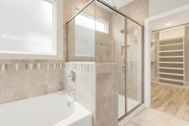 5087 Sundrop Ln, Little River, SC 29566 - bathroom featuring a bath, a spacious closet, and a stall shower