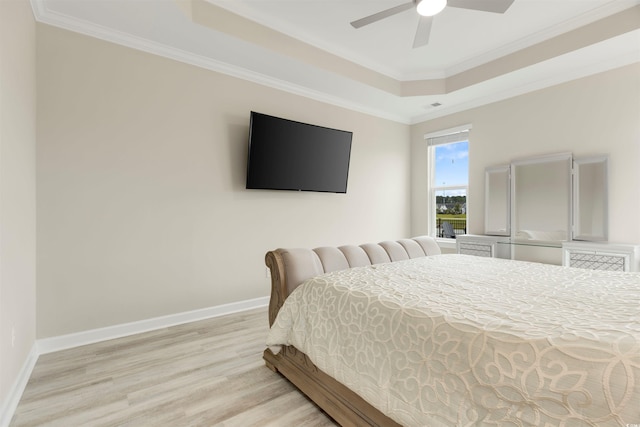 5087 Sundrop Ln, Little River, SC 29566 - bedroom with a tray ceiling, light wood-type flooring, crown molding, and ceiling fan
