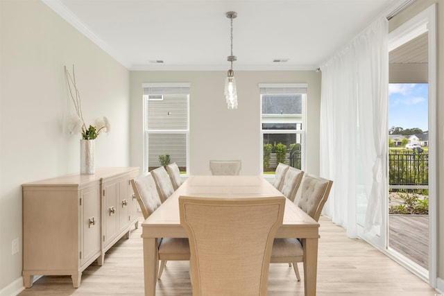5087 Sundrop Ln, Little River, SC 29566 - dining room with light wood-style flooring and crown molding