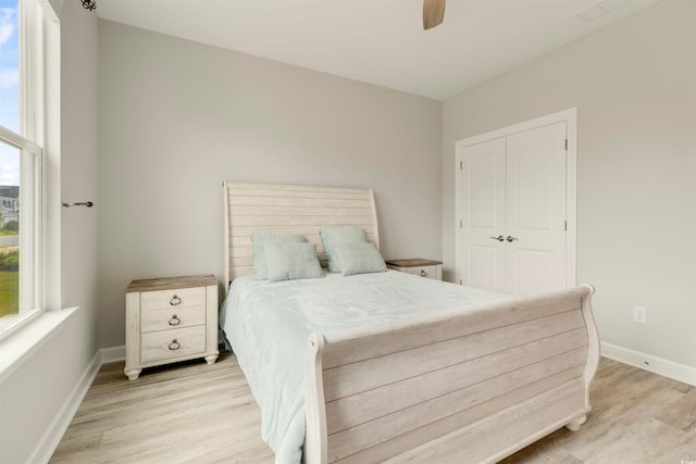 5087 Sundrop Ln, Little River, SC 29566 - bedroom with light wood-style floors, multiple windows, ceiling fan, and a closet