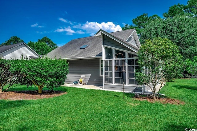 220 Gateway Dr, Little River, SC 29566 - rear view of property featuring a yard, roof with shingles, and a sunroom