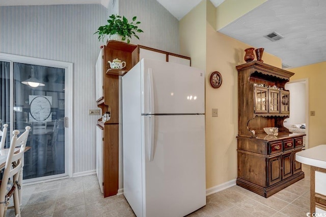 220 Gateway Dr, Little River, SC 29566 - kitchen with freestanding refrigerator, wallpapered walls, and light tile patterned flooring