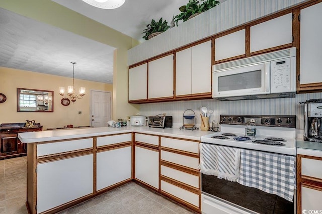 220 Gateway Dr, Little River, SC 29566 - kitchen featuring white appliances, a peninsula, light countertops, a chandelier, and white cabinetry