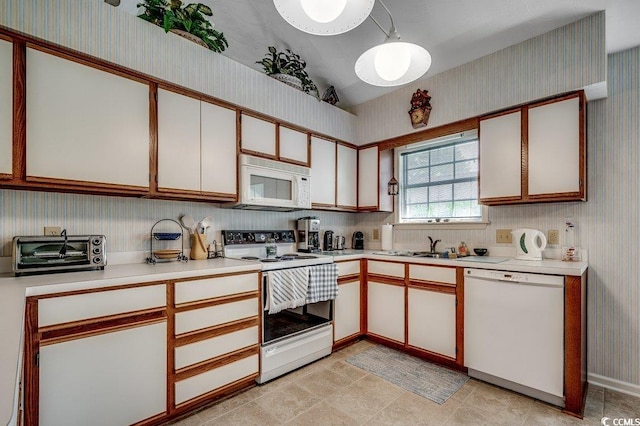 220 Gateway Dr, Little River, SC 29566 - kitchen featuring white appliances, wallpapered walls, light countertops, and lofted ceiling