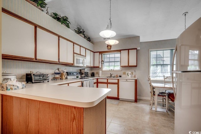 220 Gateway Dr, Little River, SC 29566 - kitchen with white appliances, wallpapered walls, light countertops, a peninsula, and vaulted ceiling