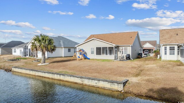 755 Wintercreeper Dr, Longs, SC 29568 - back of property with an outdoor fire pit, a sunroom, a water view, and a playground