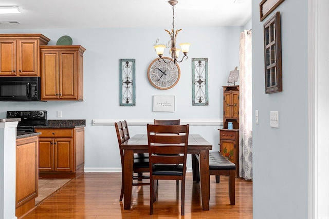 755 Wintercreeper Dr, Longs, SC 29568 - dining area with light wood-type flooring and a chandelier