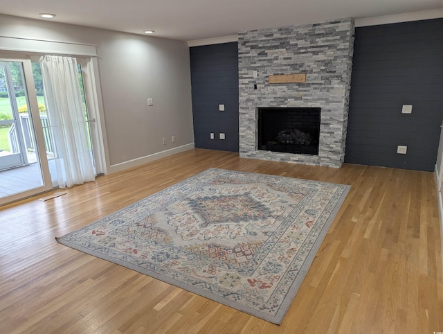 4719 National Dr, Myrtle Beach, SC 29579 - living room with a fireplace, light wood-style flooring, an accent wall, and recessed lighting