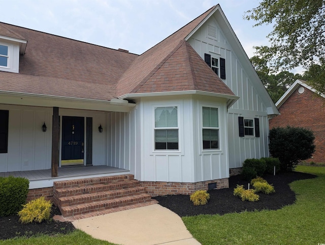 4719 National Dr, Myrtle Beach, SC 29579 - view of front facade with board and batten siding, covered porch, and a shingled roof