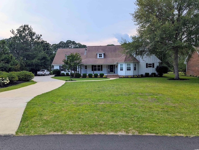 4719 National Dr, Myrtle Beach, SC 29579 - view of front of property featuring concrete driveway, a porch, a front yard, and board and batten siding
