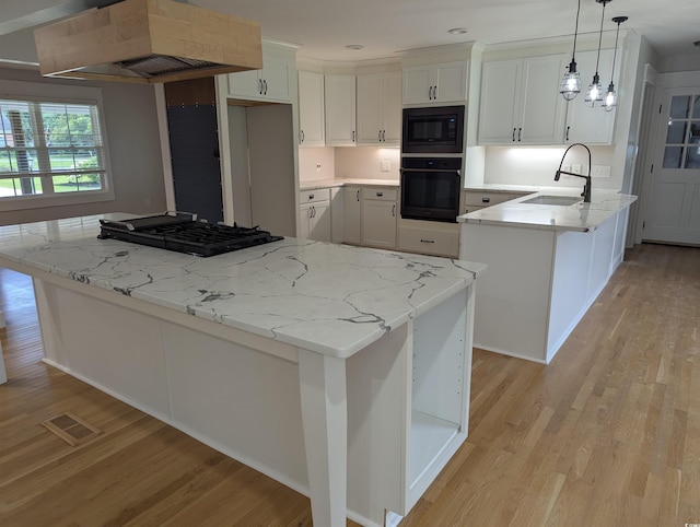 4719 National Dr, Myrtle Beach, SC 29579 - kitchen featuring black appliances, custom exhaust hood, a peninsula, light wood finished floors, and white cabinets