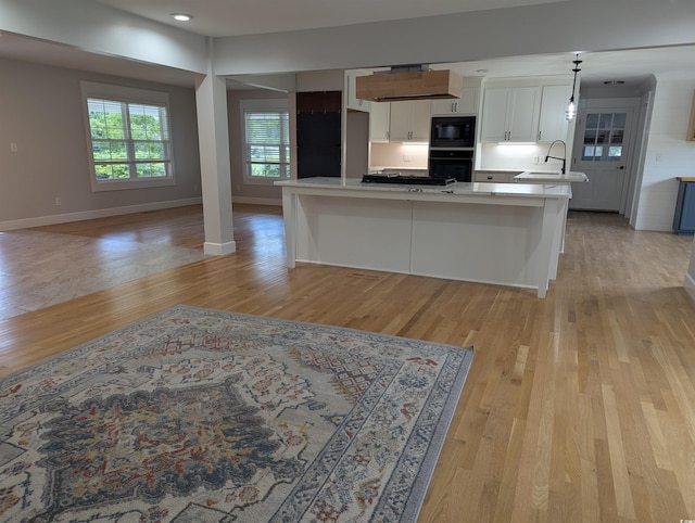 4719 National Dr, Myrtle Beach, SC 29579 - kitchen with black appliances, white cabinetry, light countertops, and light wood finished floors