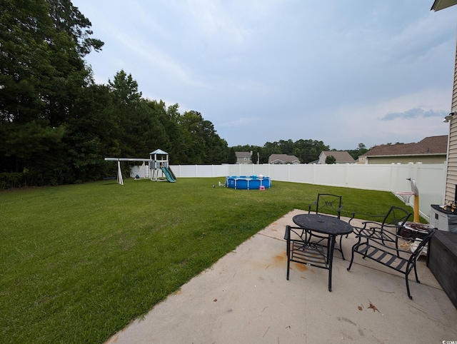 236 Haley Brooke Dr, Conway, SC 29526 - fenced backyard featuring a patio area, a playground, and an outdoor fire pit