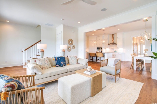 1627 Sayebrook Pkwy, Myrtle Beach, SC 29588 - living room featuring stairway, ceiling fan, crown molding, light wood-style flooring, and recessed lighting