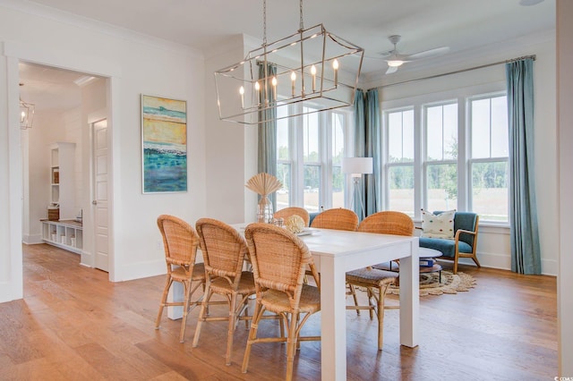 1627 Sayebrook Pkwy, Myrtle Beach, SC 29588 - dining room featuring ornamental molding, light wood-type flooring, ceiling fan, and a chandelier