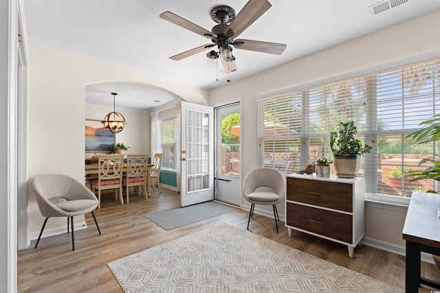 312 Caldera Ct, Murrells Inlet, SC 29576 - living area with wood finished floors, a ceiling fan, arched walkways, and a chandelier