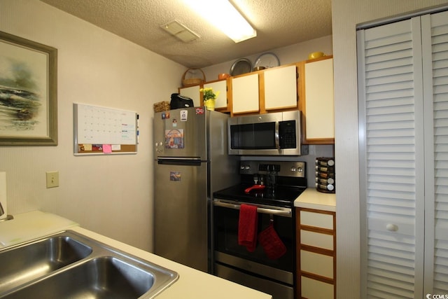 423 Tree Top Ct Unit 23-B, Myrtle Beach, SC 29588 - kitchen featuring stainless steel appliances, light countertops, and a textured ceiling