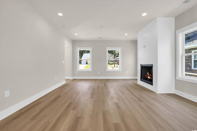 4329 Landing Rd, Little River, SC 29566 - unfurnished living room with a fireplace, plenty of natural light, light wood finished floors, and recessed lighting