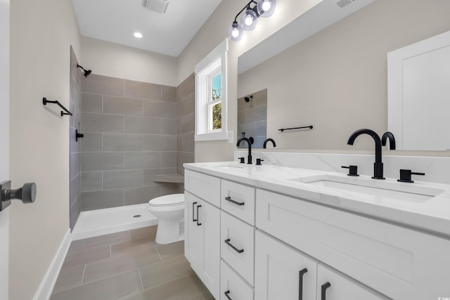 4329 Landing Rd, Little River, SC 29566 - bathroom featuring double vanity, a tile shower, tile patterned flooring, and recessed lighting