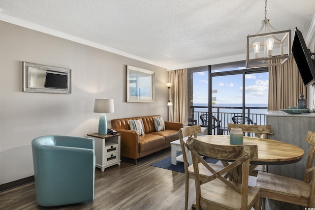 6900 N Ocean Blvd Unit 834, Myrtle Beach, SC 29572 - living area with a textured ceiling, dark wood-style floors, crown molding, expansive windows, and a chandelier