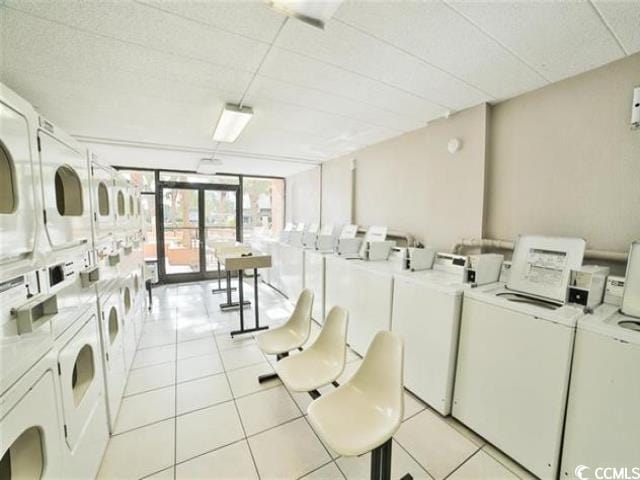 6900 N Ocean Blvd Unit 834, Myrtle Beach, SC 29572 - community laundry featuring independent washer and dryer, estacked washer and dryer, and light tile patterned flooring