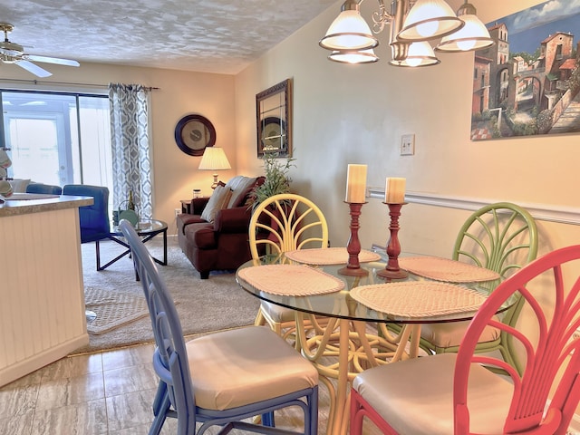 3700 Golf Colony Ln Unit 26-O, Little River, SC 29566 - dining space featuring ceiling fan, a chandelier, and a textured ceiling