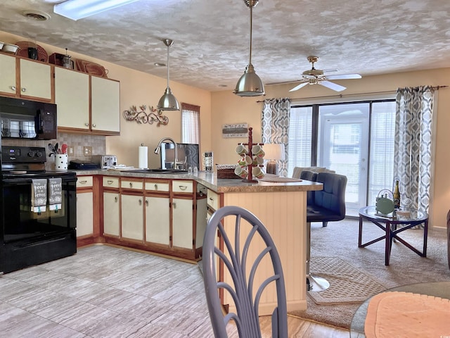 3700 Golf Colony Ln Unit 26-O, Little River, SC 29566 - kitchen with black appliances, a peninsula, backsplash, hanging light fixtures, and a textured ceiling