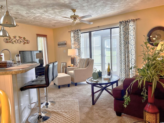 3700 Golf Colony Ln Unit 26-O, Little River, SC 29566 - living area featuring healthy amount of natural light, carpet floors, a textured ceiling, and ceiling fan