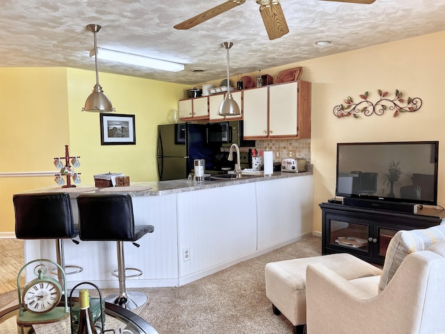 3700 Golf Colony Ln Unit 26-O, Little River, SC 29566 - kitchen with freestanding refrigerator, a peninsula, a ceiling fan, decorative light fixtures, and a textured ceiling