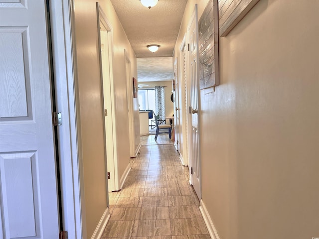 3700 Golf Colony Ln Unit 26-O, Little River, SC 29566 - corridor featuring a textured ceiling and baseboards