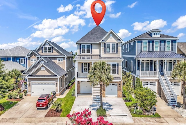 1112 Whispering Winds Dr, Myrtle Beach, SC 29579 - coastal home featuring concrete driveway, a garage, board and batten siding, stairs, and a shingled roof