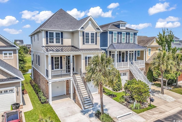 1112 Whispering Winds Dr, Myrtle Beach, SC 29579 - beach home featuring stairs, covered porch, a standing seam roof, and driveway