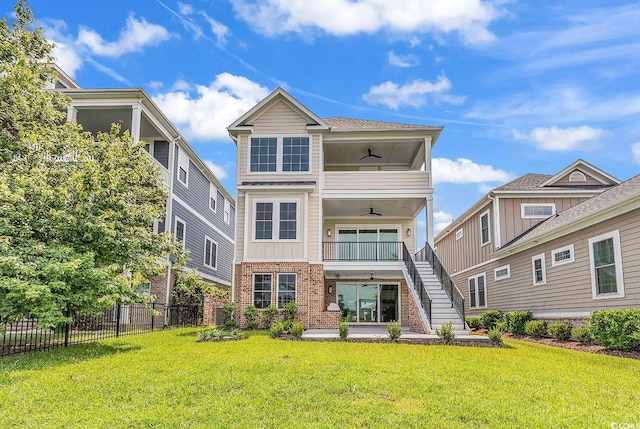 1112 Whispering Winds Dr, Myrtle Beach, SC 29579 - back of property with a ceiling fan, stairs, brick siding, and a balcony