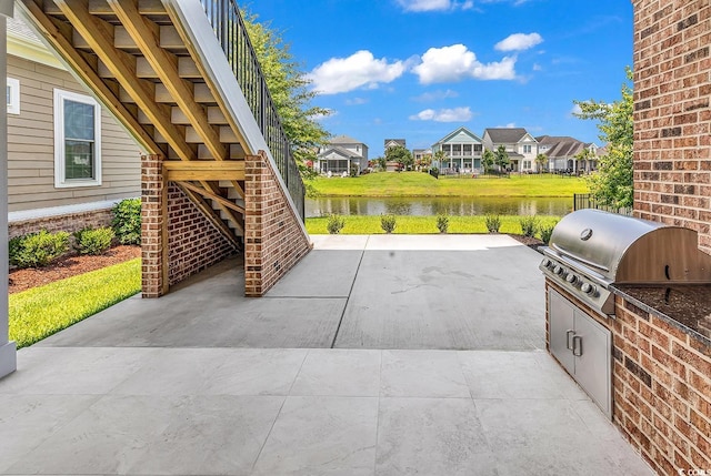 1112 Whispering Winds Dr, Myrtle Beach, SC 29579 - view of patio with a water view, area for grilling, stairs, and a residential view