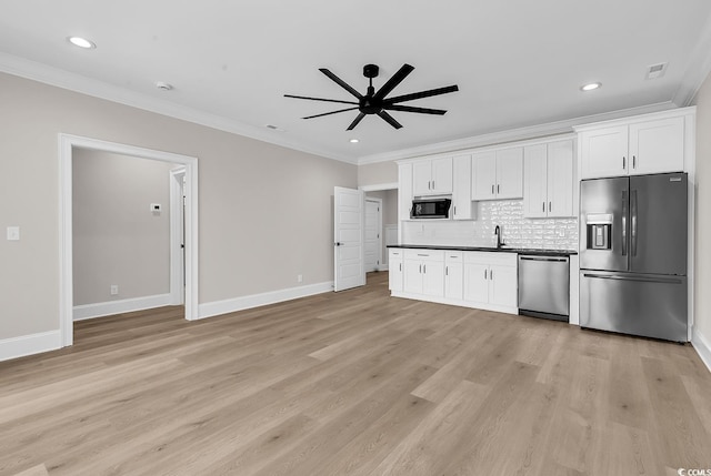 1112 Whispering Winds Dr, Myrtle Beach, SC 29579 - kitchen with appliances with stainless steel finishes, ornamental molding, ceiling fan, decorative backsplash, and white cabinets