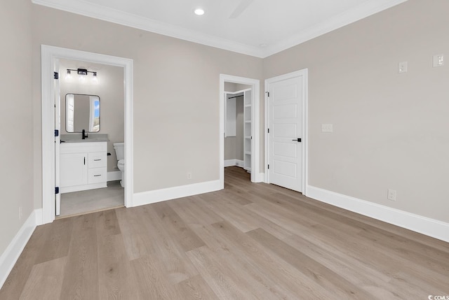1112 Whispering Winds Dr, Myrtle Beach, SC 29579 - unfurnished bedroom featuring light wood-type flooring, a spacious closet, ornamental molding, ensuite bathroom, and a closet