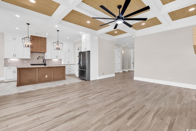 1112 Whispering Winds Dr, Myrtle Beach, SC 29579 - kitchen with high quality fridge, open floor plan, coffered ceiling, light countertops, and backsplash